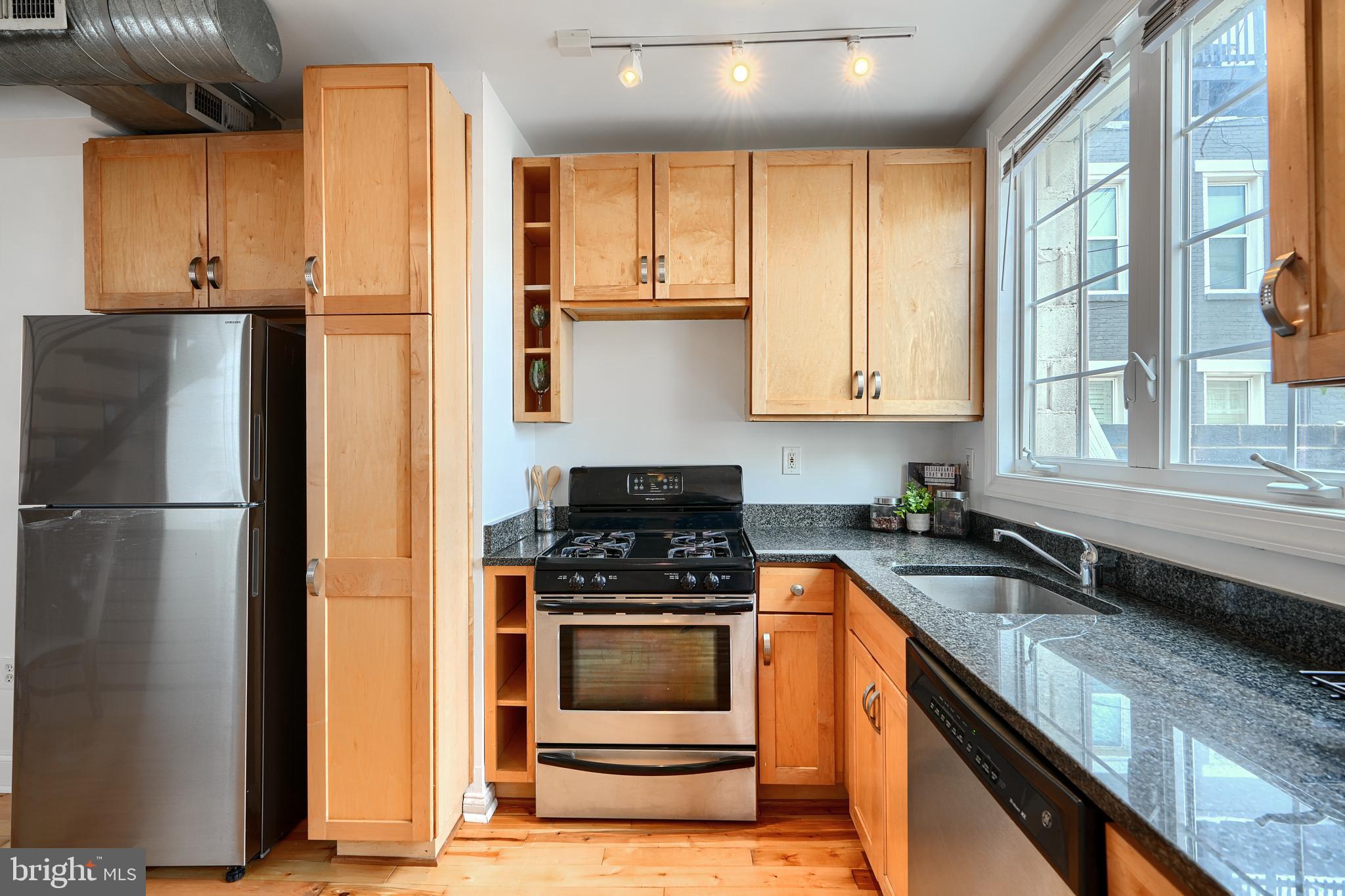 1600 Patapsco Street Baltimore, MD 21230 - Photo 11 of 40 a kitchen with stainless steel appliances granite countertop a stove a refrigerator and a sink