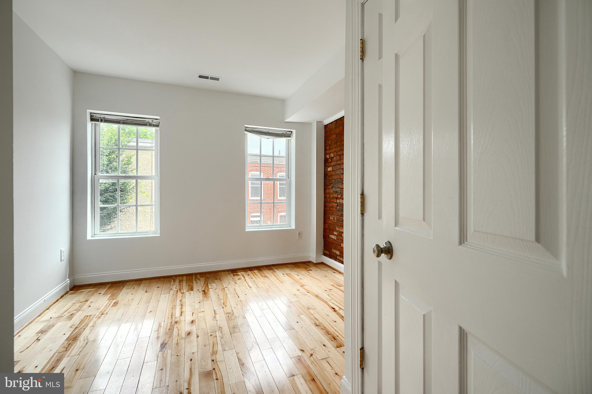 1600 Patapsco Street Baltimore, MD 21230 - Photo 15 of 40 an empty room with wooden floor and windows