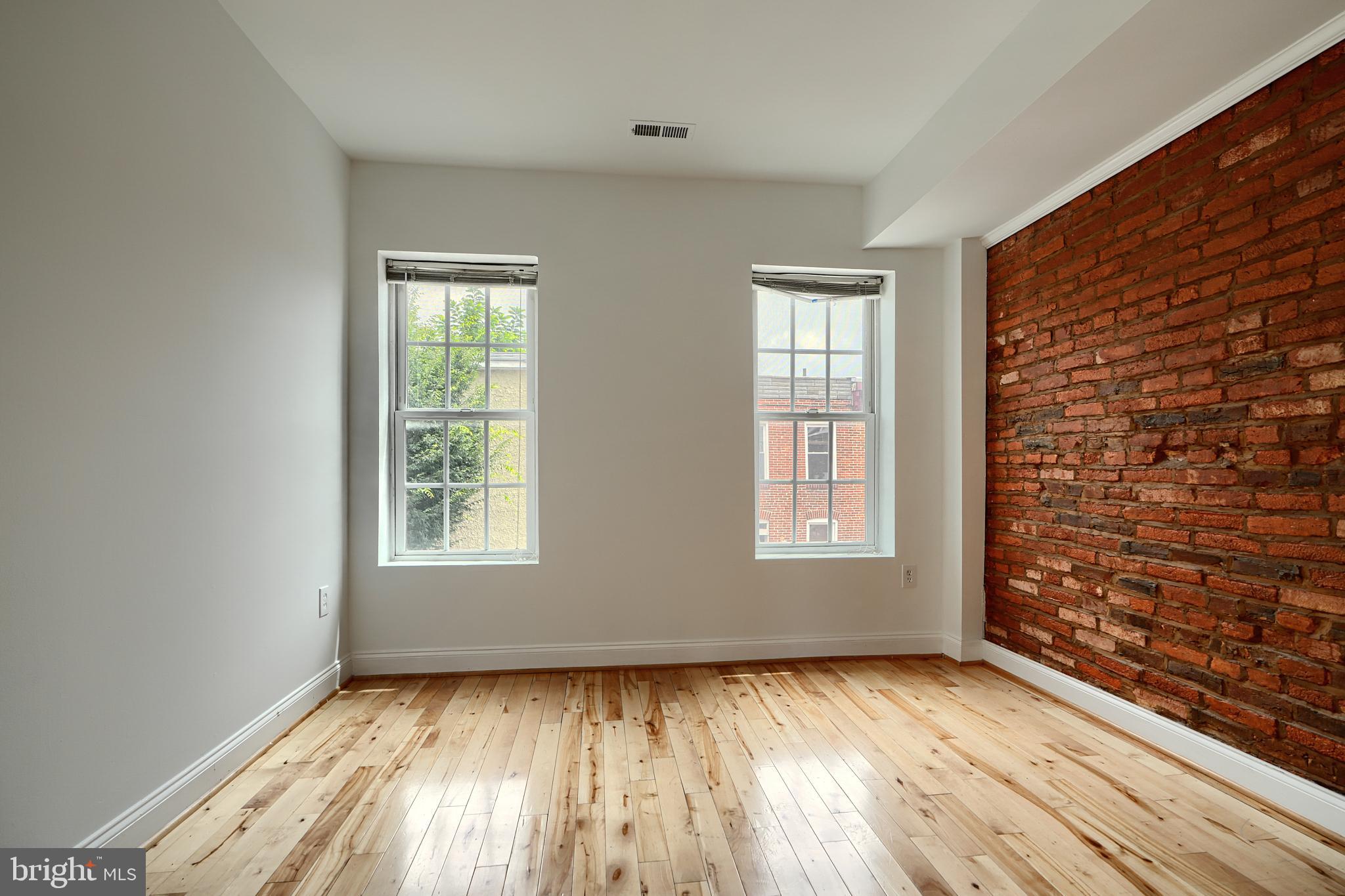 1600 Patapsco Street Baltimore, MD 21230 - Photo 16 of 40 an empty room with wooden floor and windows