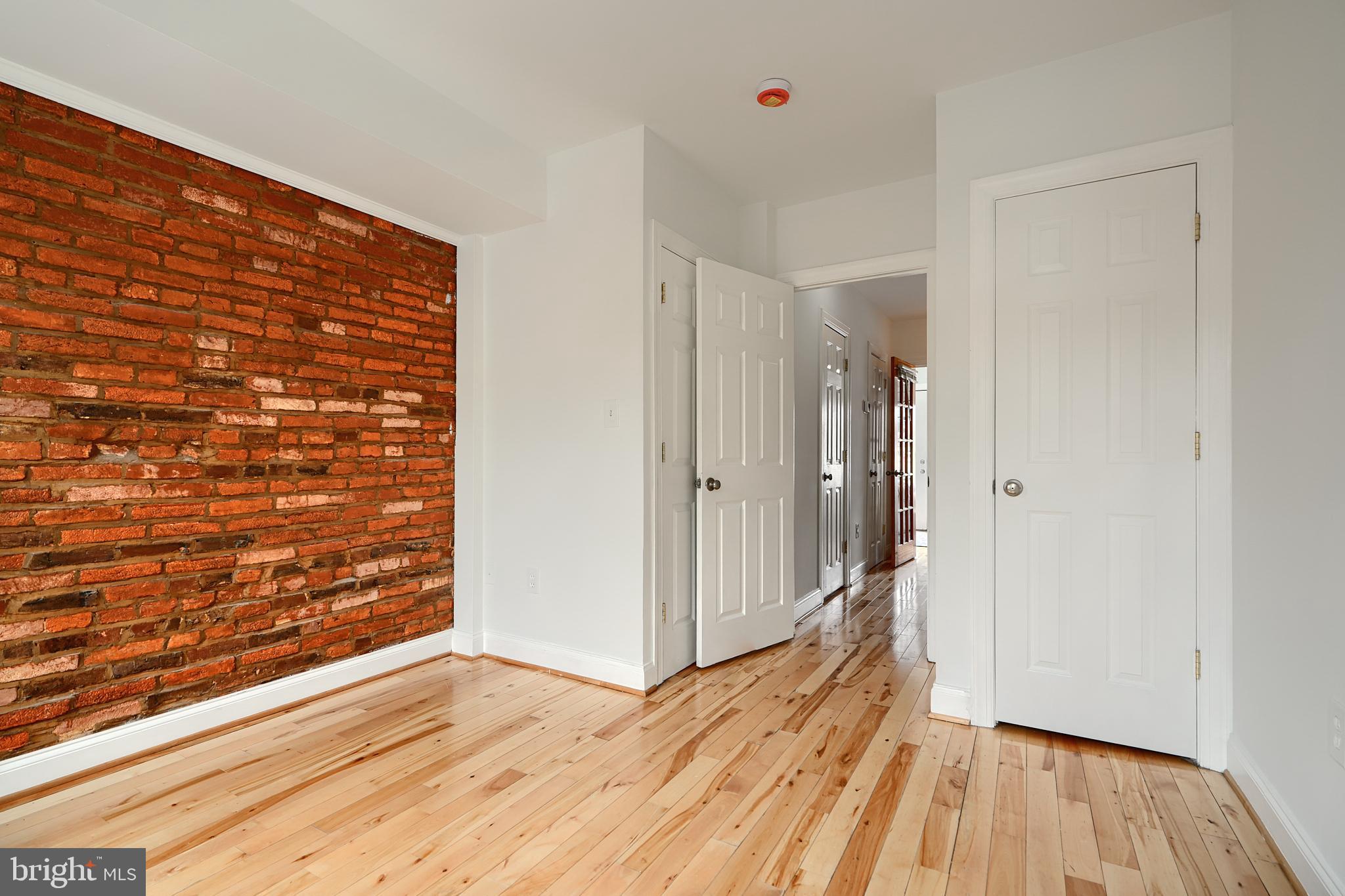 1600 Patapsco Street Baltimore, MD 21230 - Photo 17 of 40 a view of a hallway with wooden floor and a bathroom