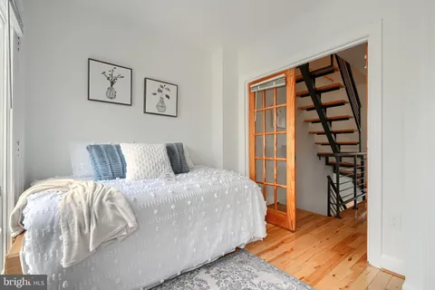 a view of bedroom with a bed and wooden floor