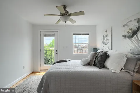 a bedroom with a bed and a potted plant