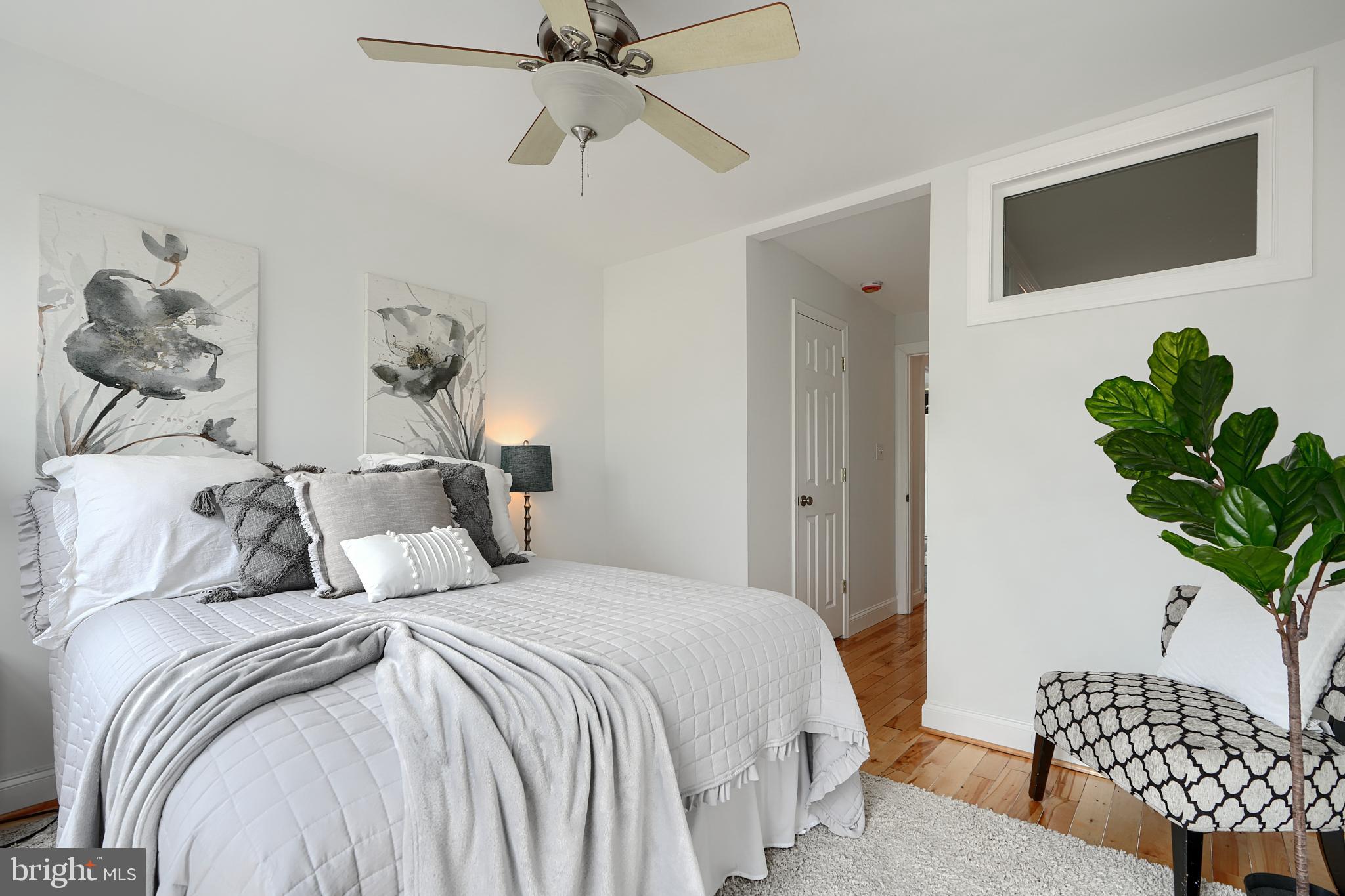 1600 Patapsco Street Baltimore, MD 21230 - Photo 29 of 40 a bedroom with a bed and a potted plant