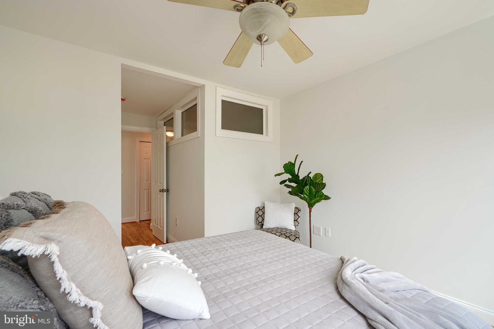 1600 Patapsco Street Baltimore, MD 21230 - Photo 30 of 40 a bedroom with a bed and a potted plant