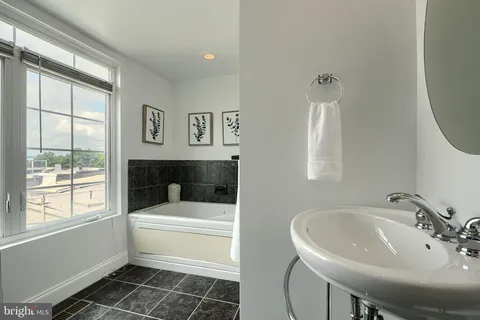 a bathroom with a sink toilet and a mirror