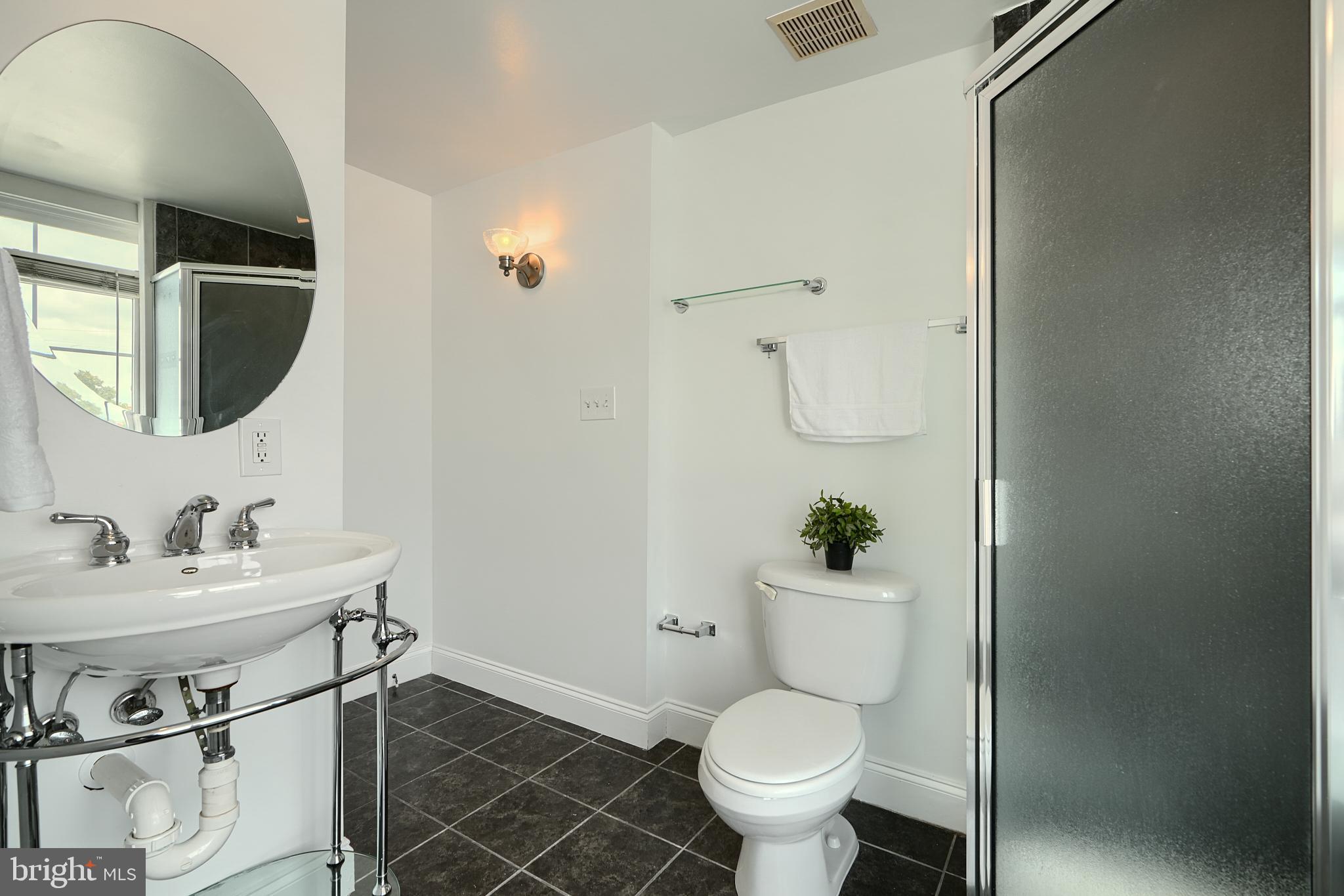 1600 Patapsco Street Baltimore, MD 21230 - Photo 37 of 40 a bathroom with a sink toilet and a mirror