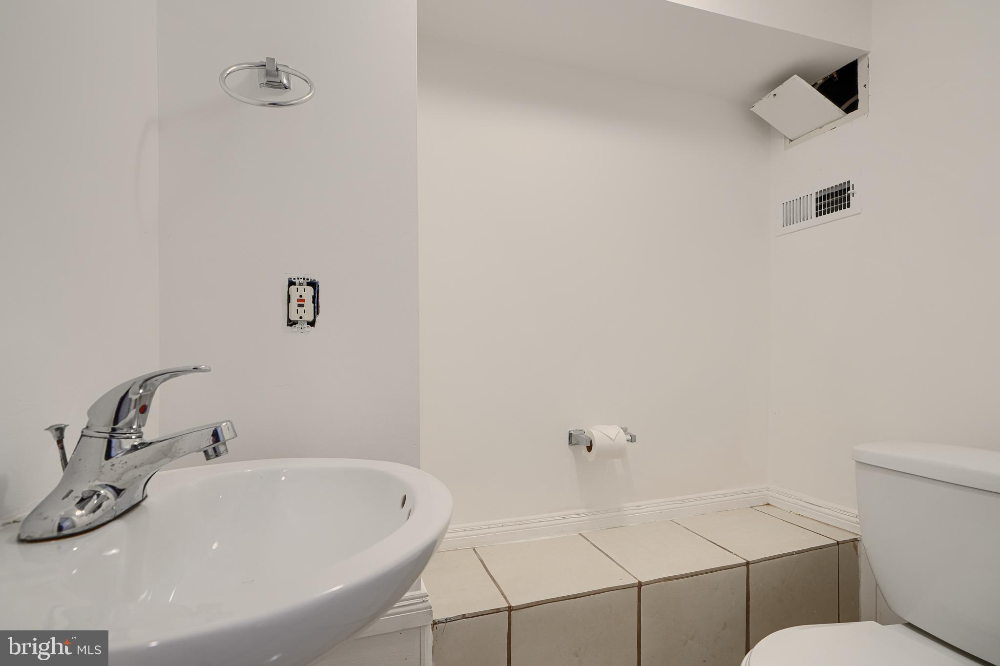 1600 Patapsco Street Baltimore, MD 21230 - Photo 40 of 40 a bathroom with a sink and a toilet