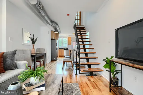 a living room with furniture fireplace and potted plants