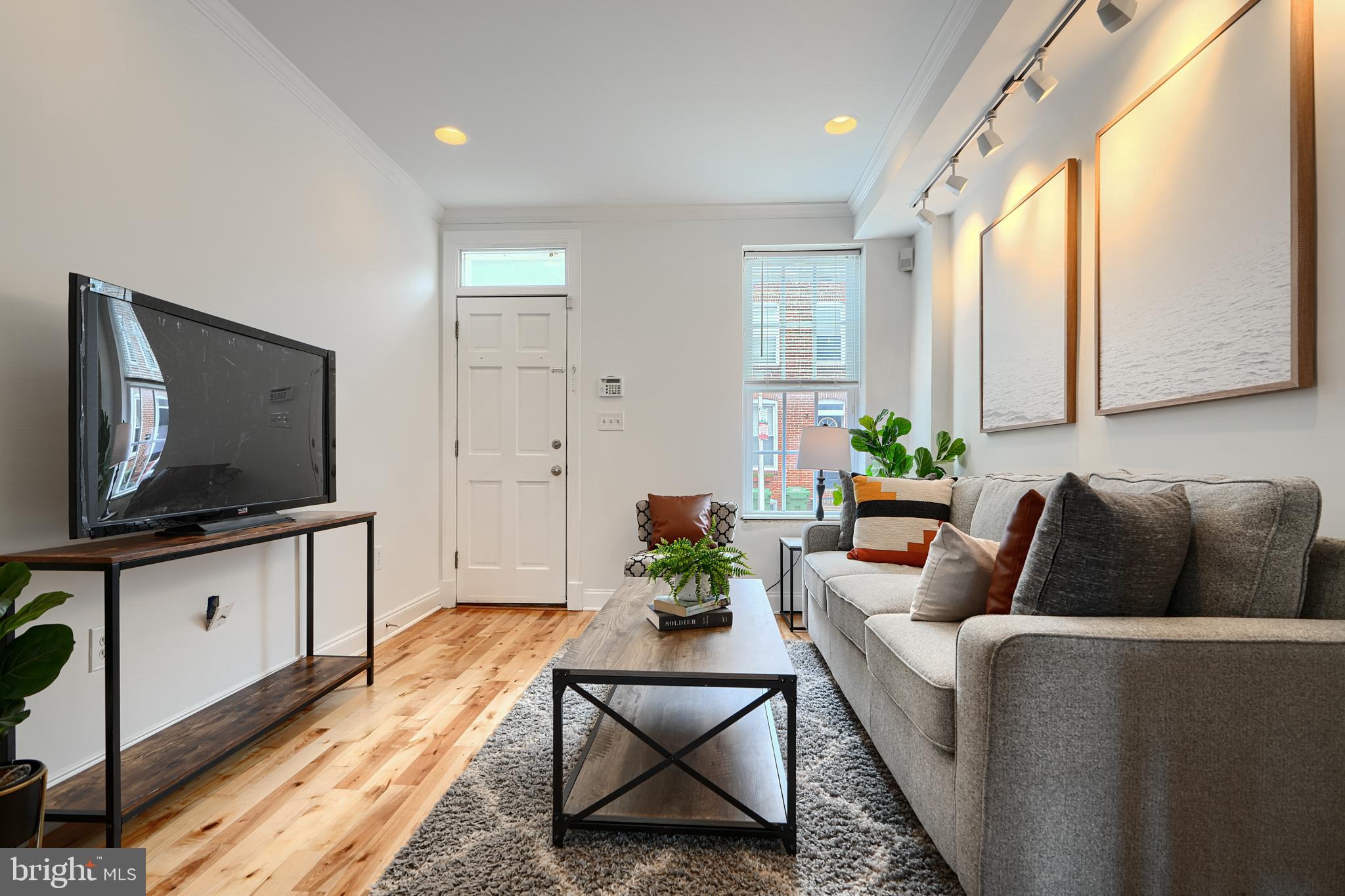 1600 Patapsco Street Baltimore, MD 21230 - Photo 5 of 40 a living room with furniture and a flat screen tv