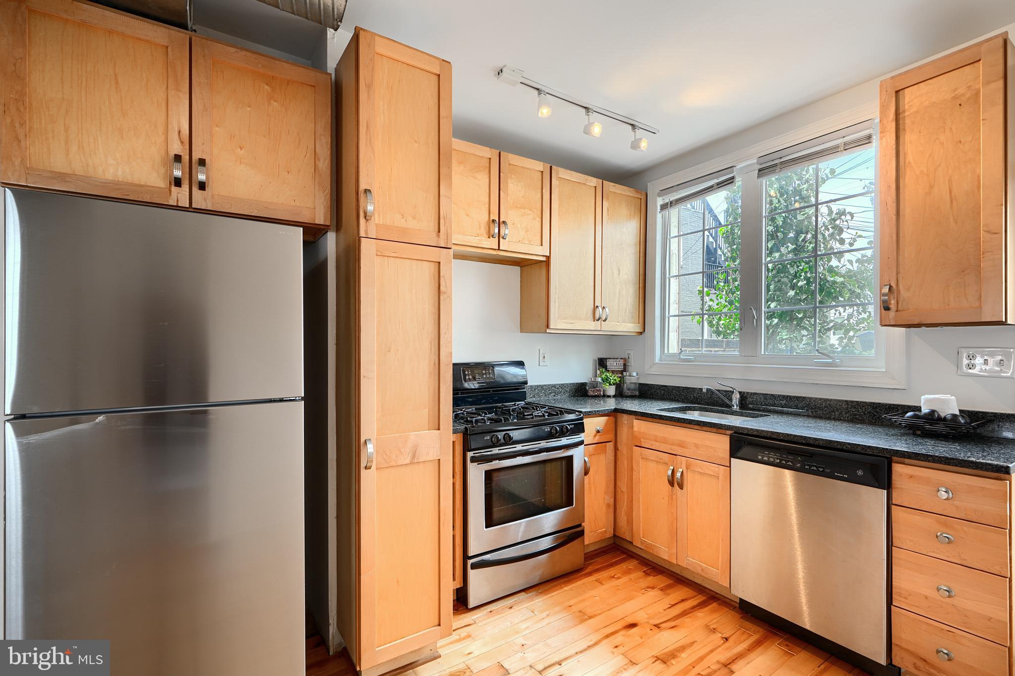 1600 Patapsco Street Baltimore, MD 21230 - Photo 10 of 40 a kitchen with stainless steel appliances a refrigerator sink and cabinets