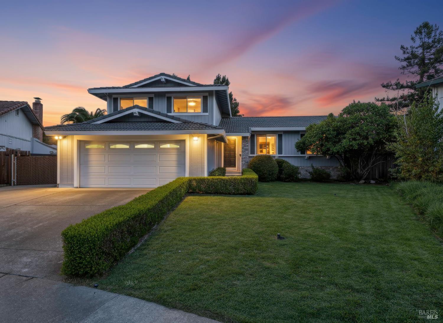 a front view of a house with a yard and garage