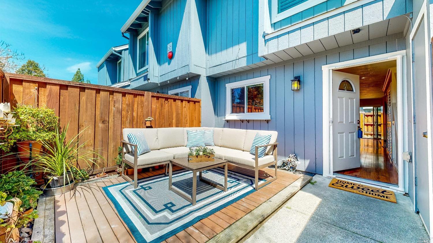 697 Racquet Club Circle Rohnert Park, CA 94928 - Photo 1 of 1 a view of a patio with a table and chairs and potted plants