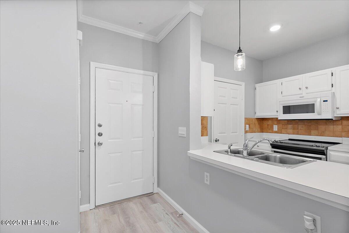 160 Veracruz Drive, Unit 422 Ponte Vedra Beach, FL 32082 - Photo 3 of 26 a view of kitchen with stainless steel appliances granite countertop a sink and cabinets