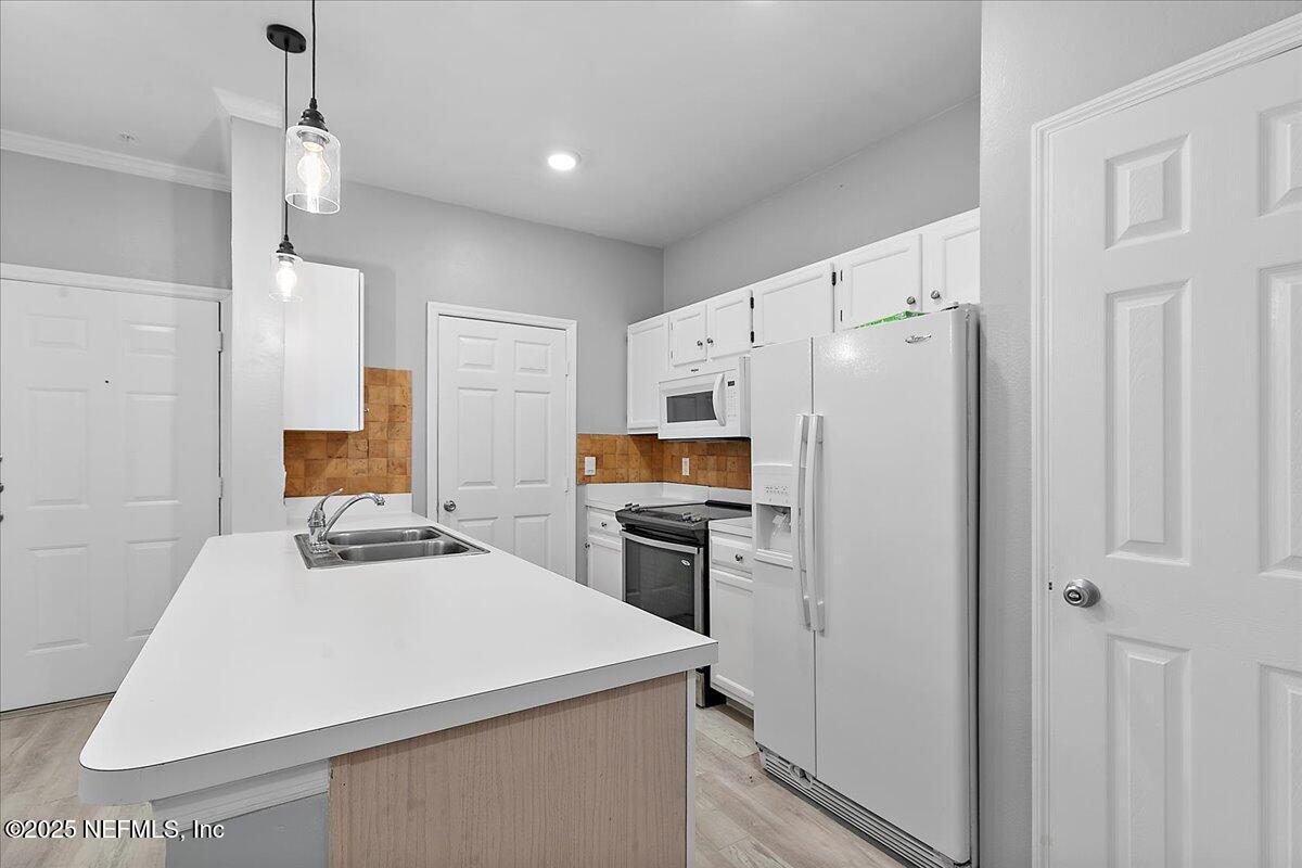 160 Veracruz Drive, Unit 422 Ponte Vedra Beach, FL 32082 - Photo 4 of 26 a kitchen with a refrigerator a stove top oven a sink and dishwasher