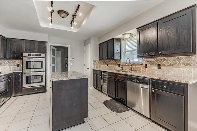 a kitchen with stainless steel appliances and cabinets