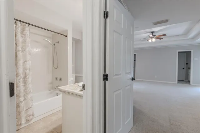 a bathroom with a bathtub shower and a sink