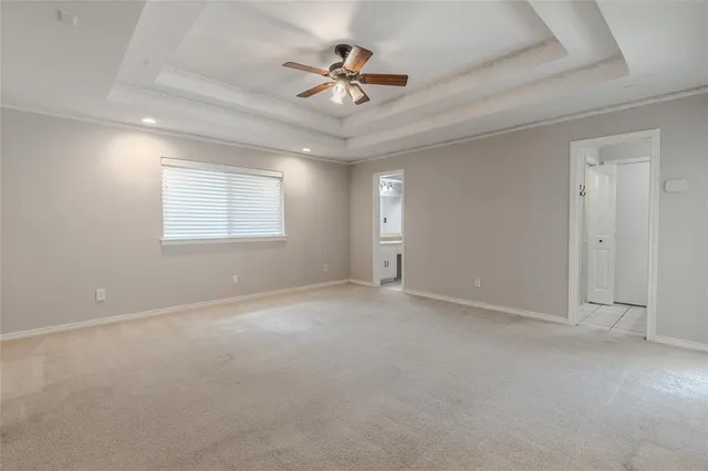 an empty room with closet and ceiling fan