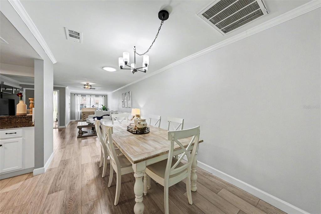 9204 Golf View Drive New Port Richey, FL 34655 - Photo 9 of 33 a view of a dining room with furniture and wooden floor