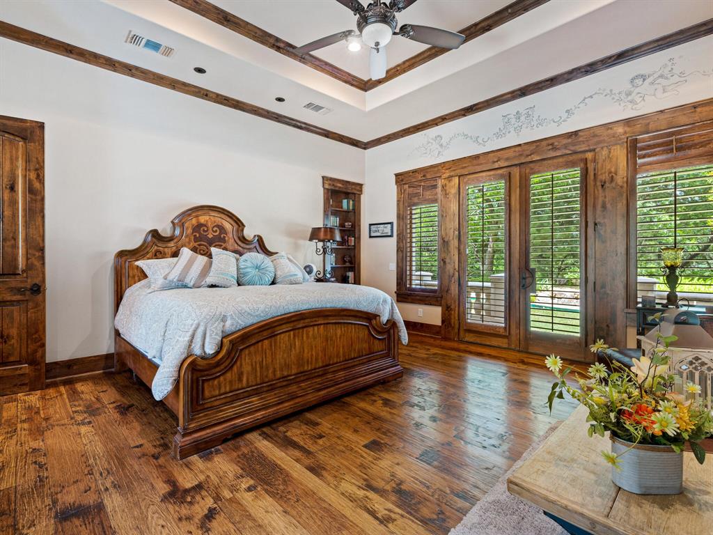 2115 Paradise Rnch Trail McKinney, TX 75071 - Photo 16 of 40 a bedroom with a large bed and a chandelier