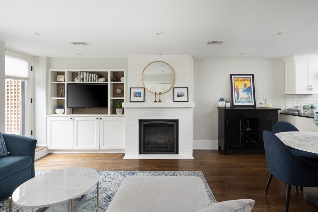 5 Dwight Street, Unit 1 Boston, MA 02118 - Photo 4 of 22 a living room with furniture a flat screen tv and a fireplace