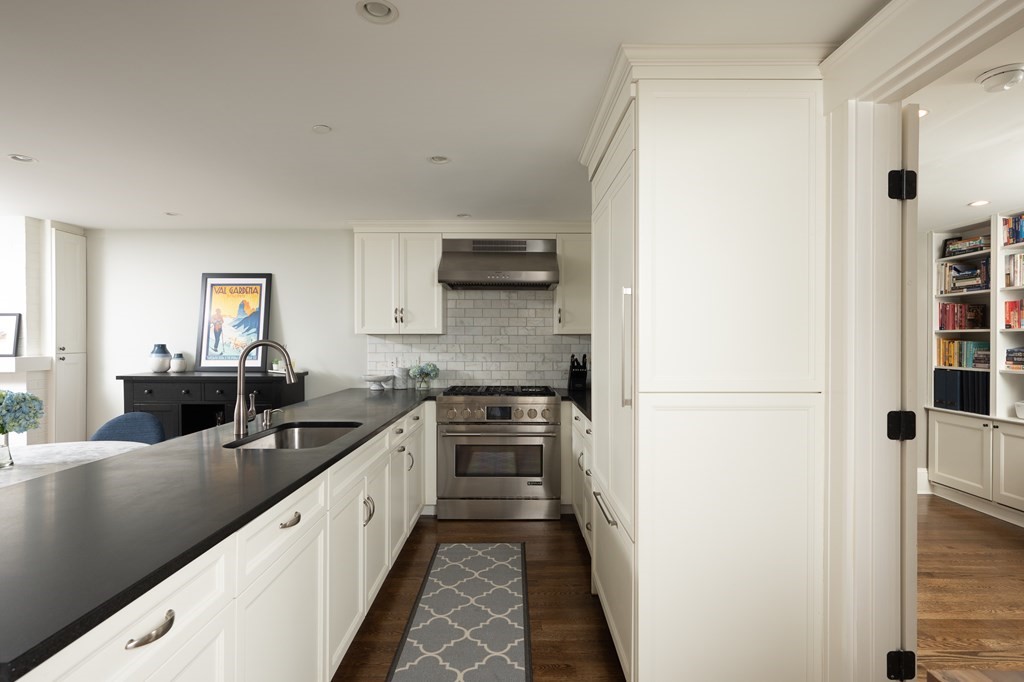 5 Dwight Street, Unit 1 Boston, MA 02118 - Photo 6 of 22 a kitchen with granite countertop a refrigerator a stove a microwave and cabinets