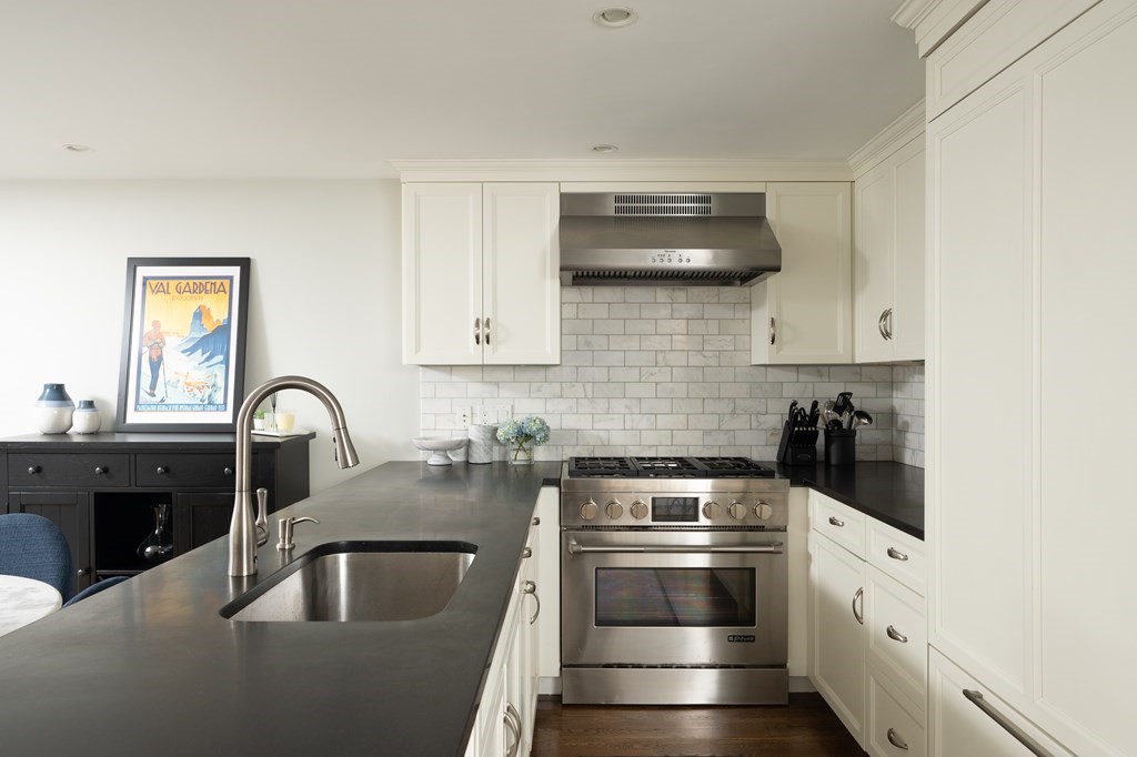 5 Dwight Street, Unit 1 Boston, MA 02118 - Photo 7 of 22 a kitchen with stainless steel appliances granite countertop a sink and a stove top oven