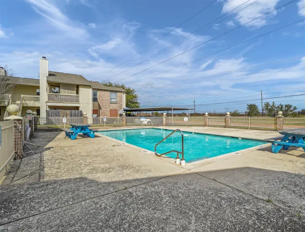 a view of a swimming pool with an outdoor seating