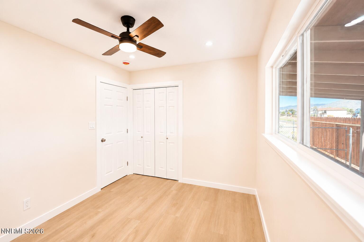 742 Ruth Street Carson City, NV 89701 - Photo 16 of 25 a view of empty room with wooden floor and fan
