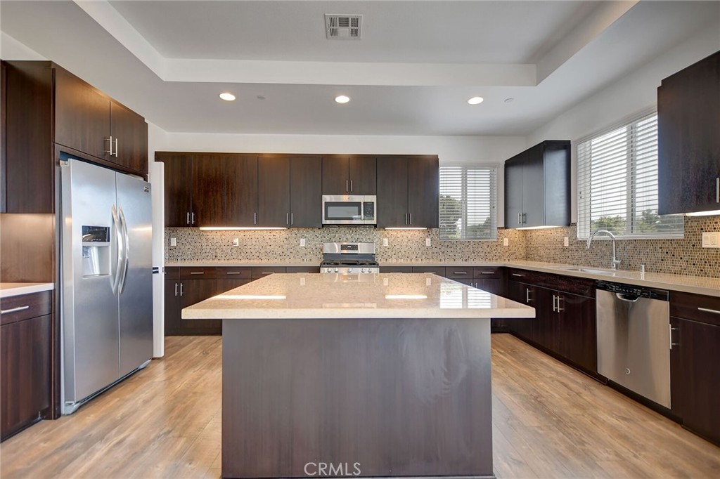 711 Brooklyn Drive Brea, CA 92821 - Photo 14 of 30 a kitchen with stainless steel appliances granite countertop a sink a stove a refrigerator and a microwave