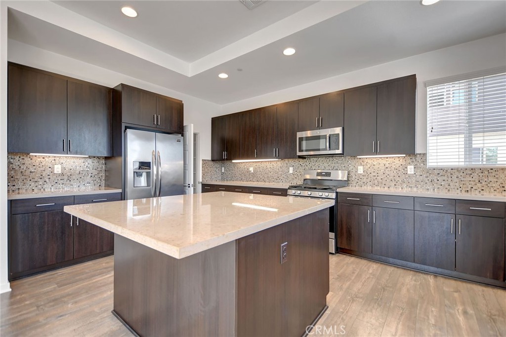711 Brooklyn Drive Brea, CA 92821 - Photo 15 of 30 a kitchen with stainless steel appliances granite countertop a sink stove microwave and refrigerator
