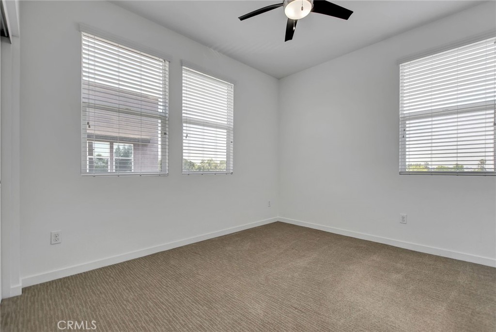 711 Brooklyn Drive Brea, CA 92821 - Photo 21 of 30 an empty room with a window and a ceiling fan