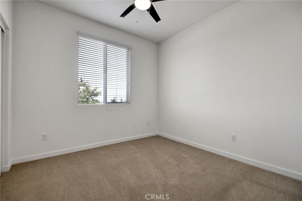 711 Brooklyn Drive Brea, CA 92821 - Photo 24 of 30 an empty room with a window and a ceiling fan