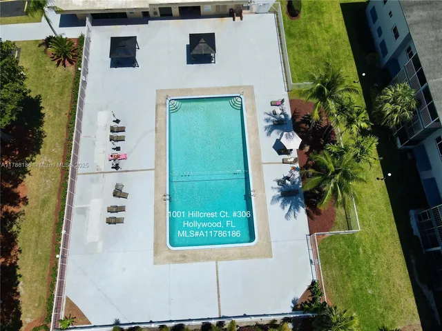 an aerial view of multiple houses with yard