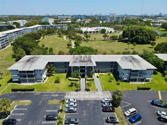 an aerial view of a house with a garden and outdoor seating