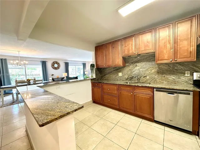 a kitchen with granite countertop sink and cabinets