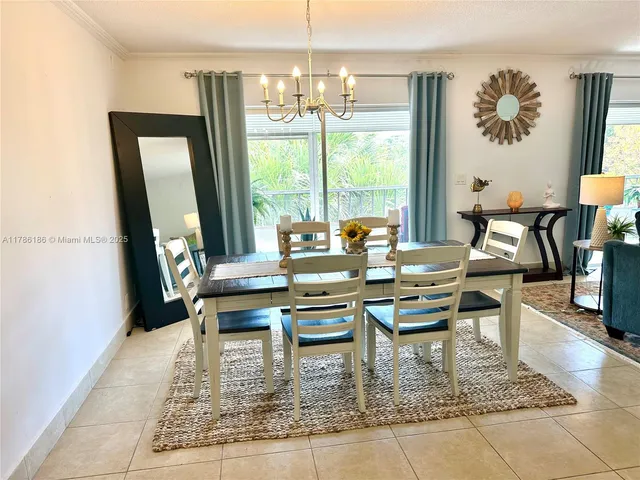 a dining room with furniture a rug and a painting