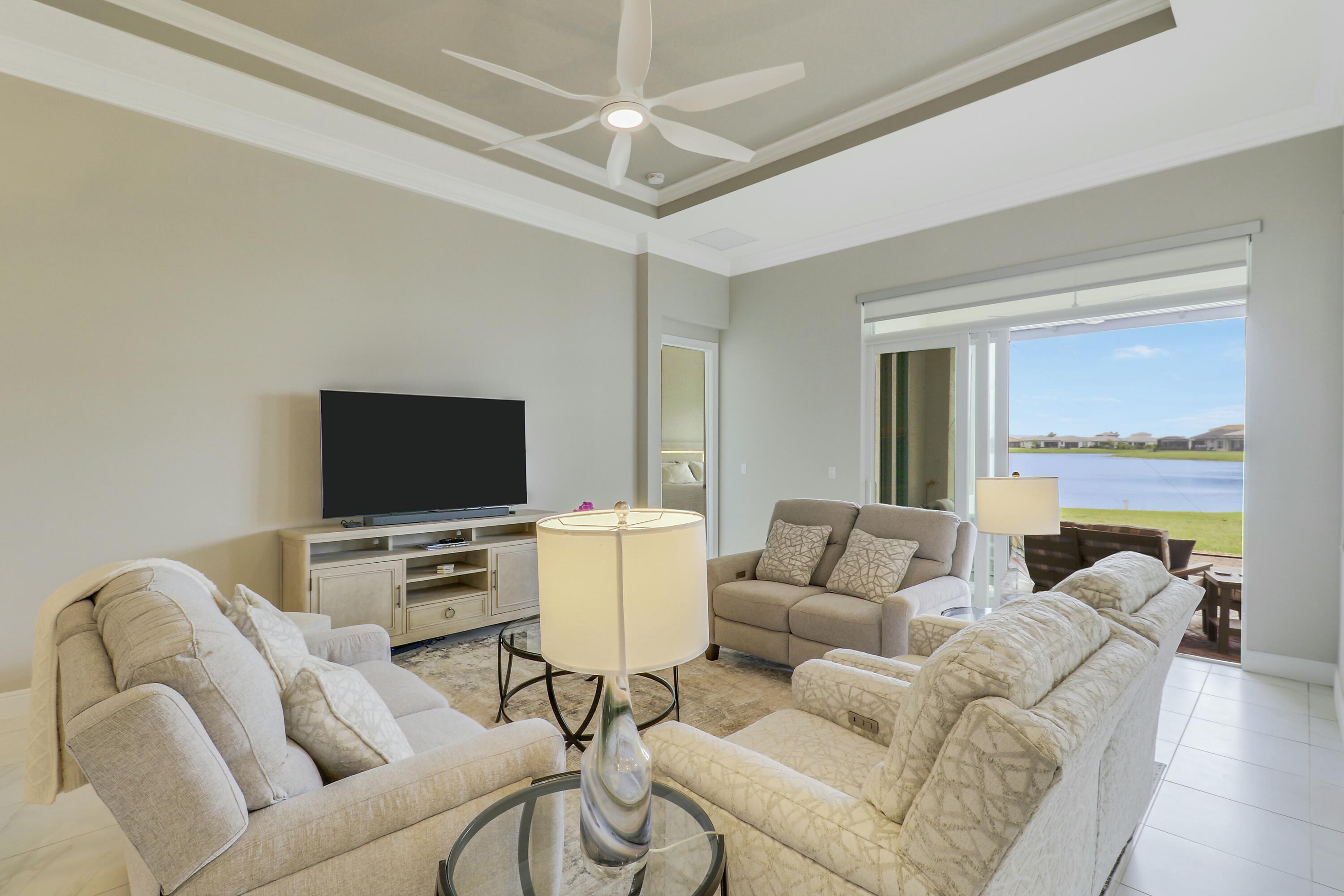 9182 Southwest Pepoli Way Port St. Lucie, FL 34987 - Photo 12 of 80 a living room with furniture and a flat screen tv