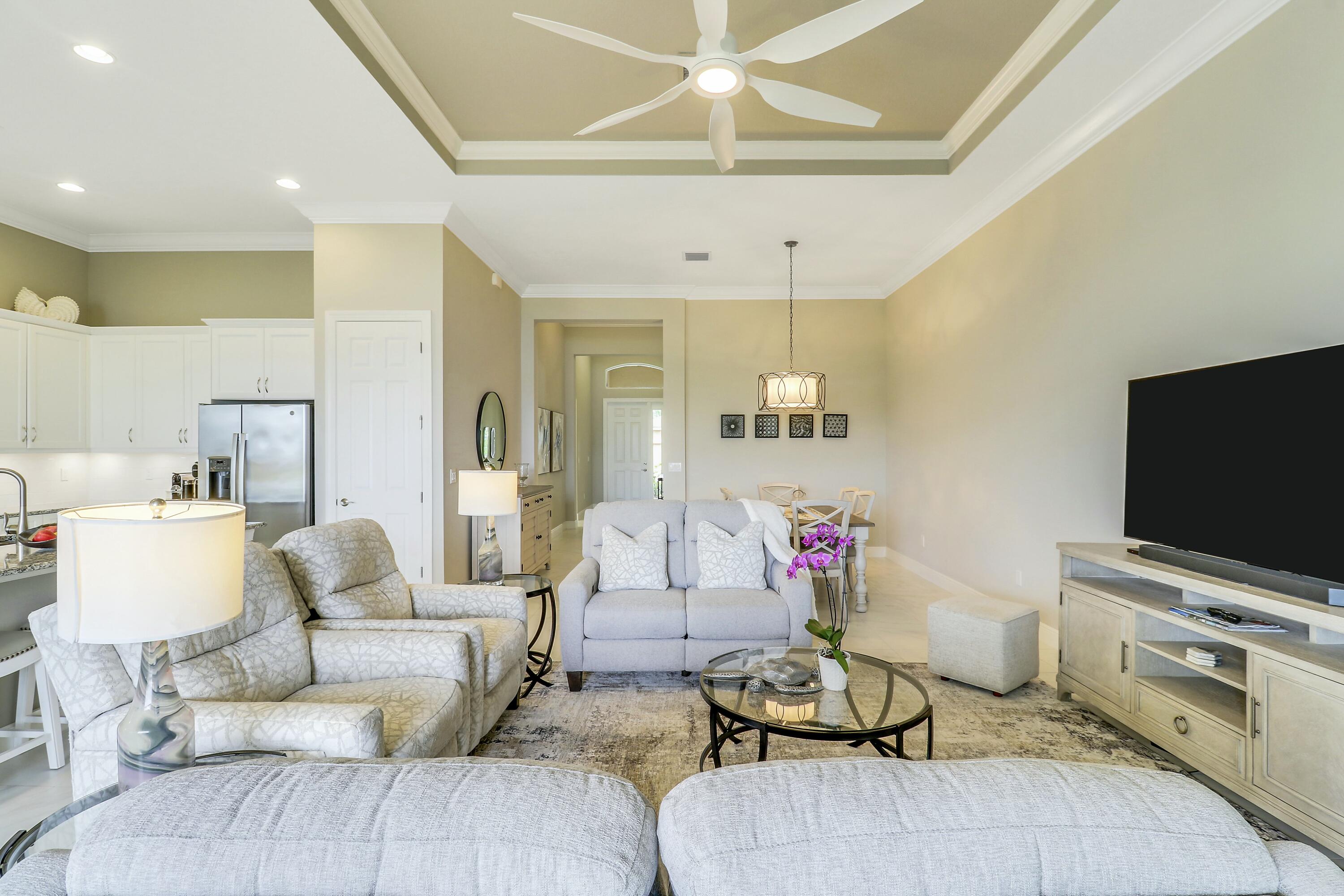 9182 Southwest Pepoli Way Port St. Lucie, FL 34987 - Photo 13 of 80 a living room with furniture and a flat screen tv