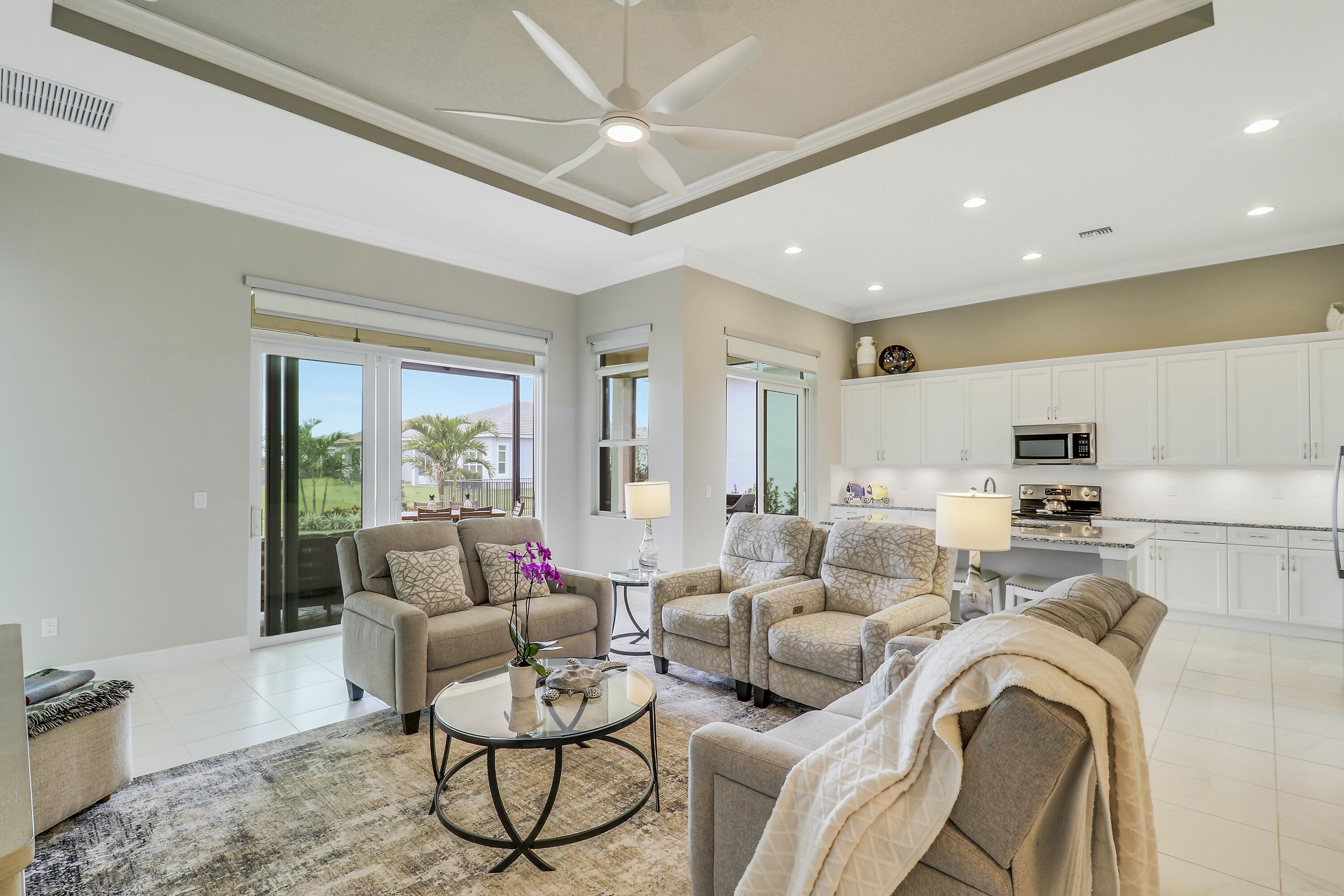9182 Southwest Pepoli Way Port St. Lucie, FL 34987 - Photo 15 of 80 a living room with furniture or couch and a dining table