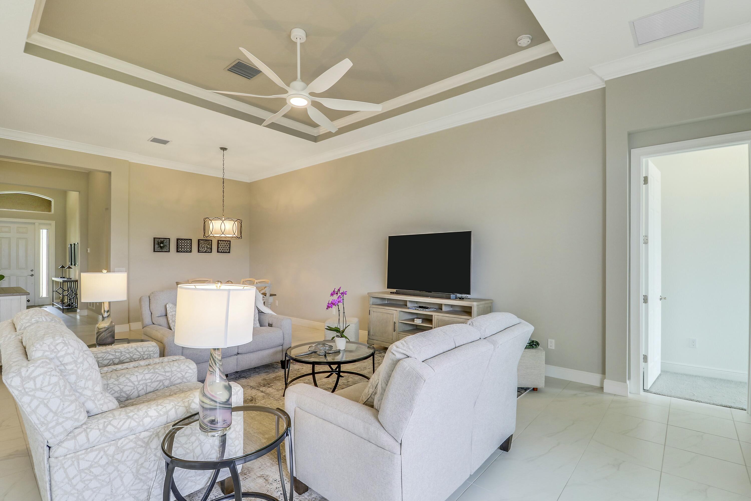 9182 Southwest Pepoli Way Port St. Lucie, FL 34987 - Photo 21 of 80 a living room with furniture and a flat screen tv