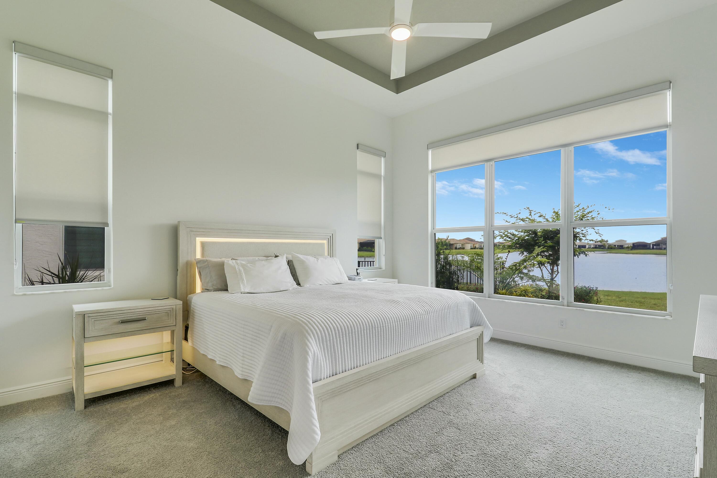9182 Southwest Pepoli Way Port St. Lucie, FL 34987 - Photo 22 of 80 a bedroom with a bed and a potted plant