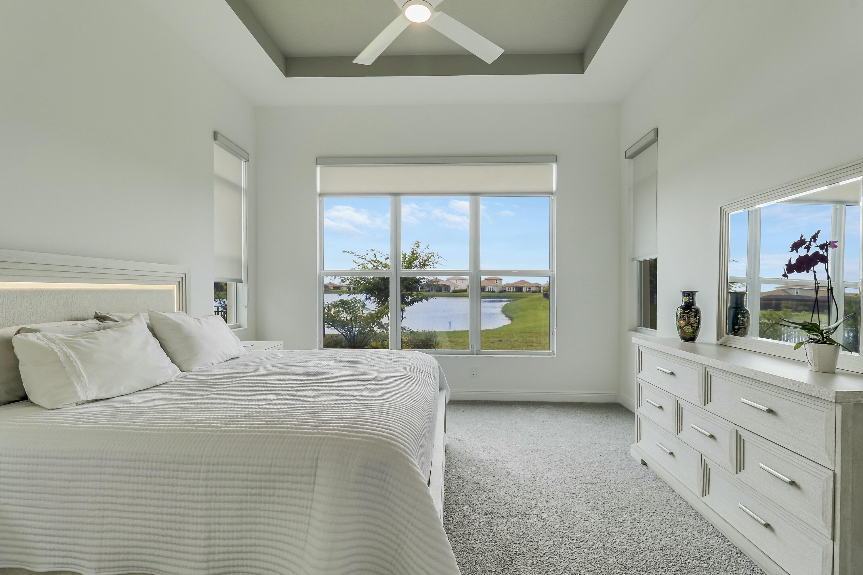 9182 Southwest Pepoli Way Port St. Lucie, FL 34987 - Photo 23 of 80 a bedroom with a bed and a large mirror