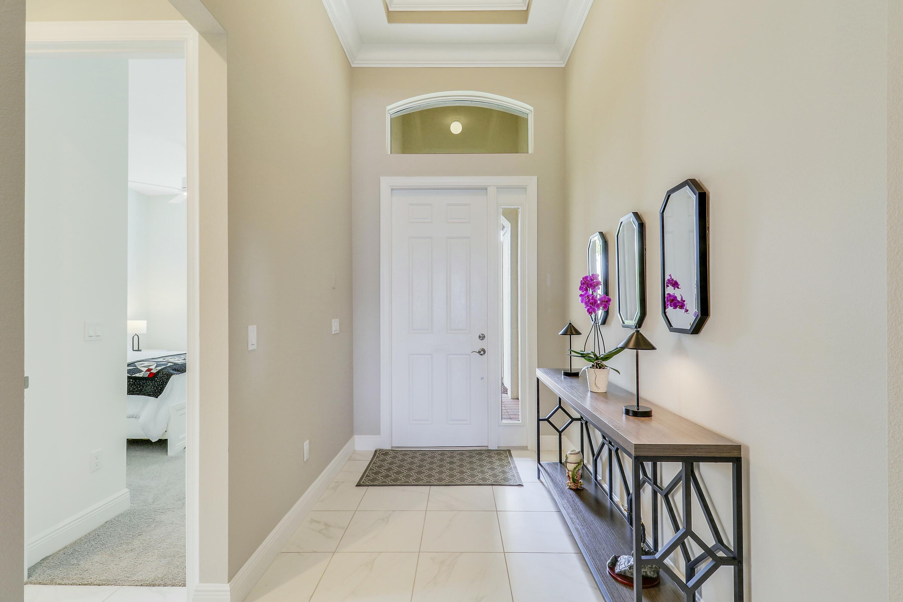 9182 Southwest Pepoli Way Port St. Lucie, FL 34987 - Photo 27 of 80 a view of a hallway with wooden floor and entryway