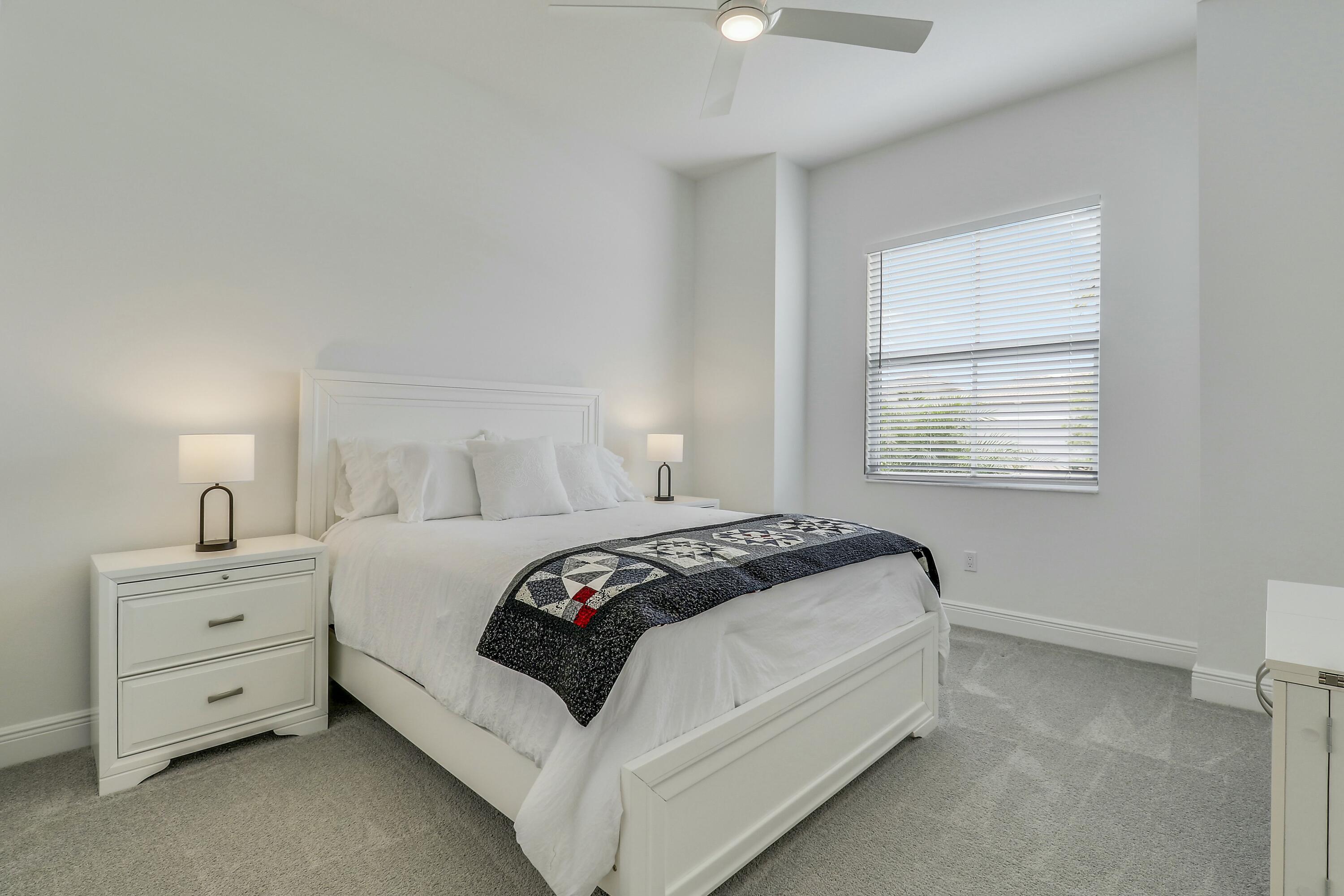 9182 Southwest Pepoli Way Port St. Lucie, FL 34987 - Photo 28 of 80 a bedroom with a bed and a window