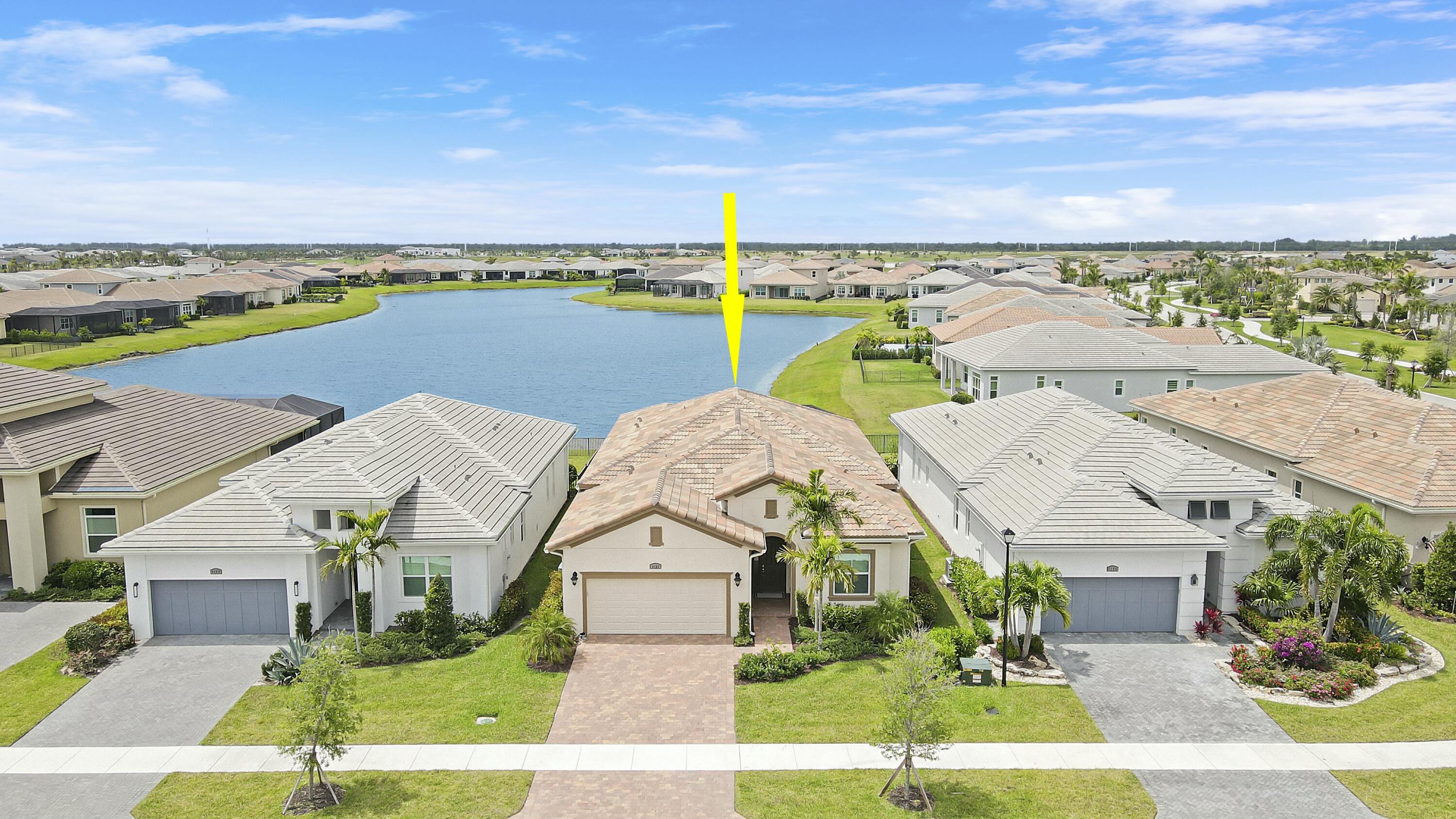 9182 Southwest Pepoli Way Port St. Lucie, FL 34987 - Photo 3 of 80 an aerial view of a house with a garden and lake view