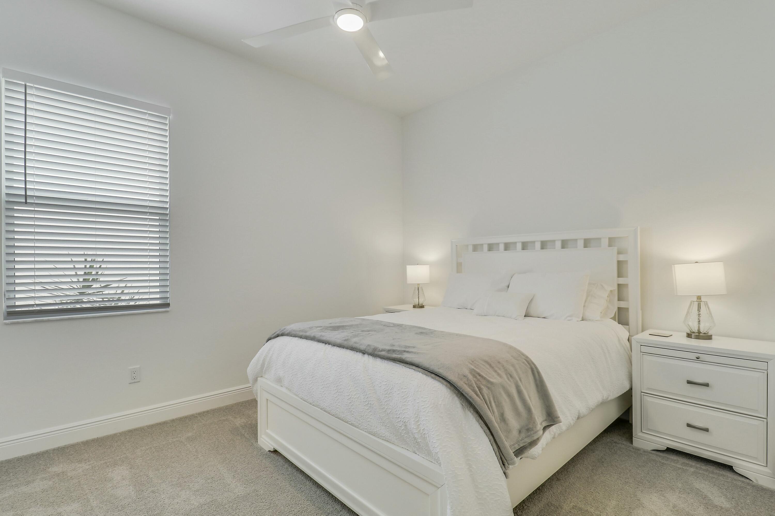 9182 Southwest Pepoli Way Port St. Lucie, FL 34987 - Photo 31 of 80 a bedroom with a bed and a window