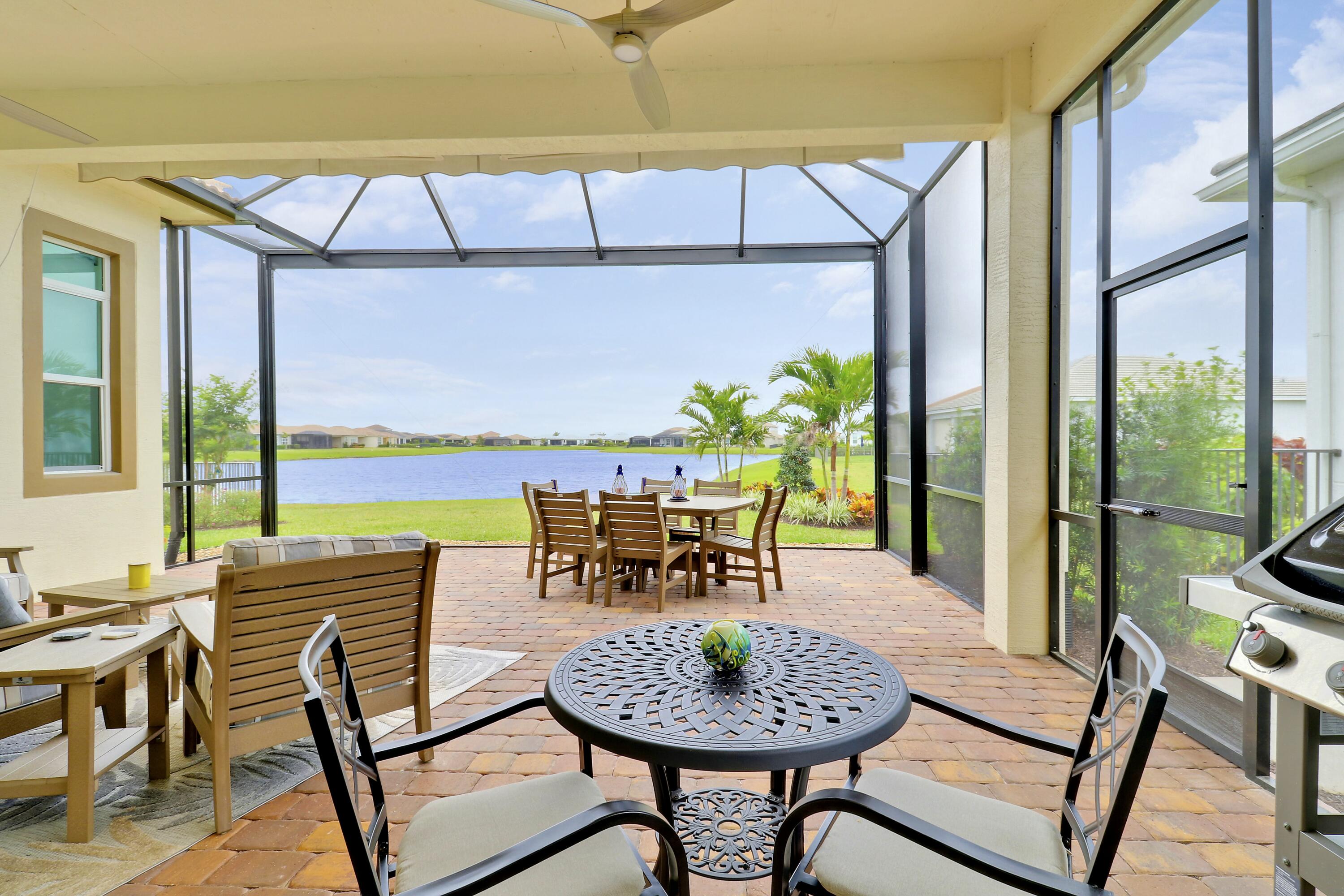 9182 Southwest Pepoli Way Port St. Lucie, FL 34987 - Photo 36 of 80 a dining room with furniture and a floor to ceiling window