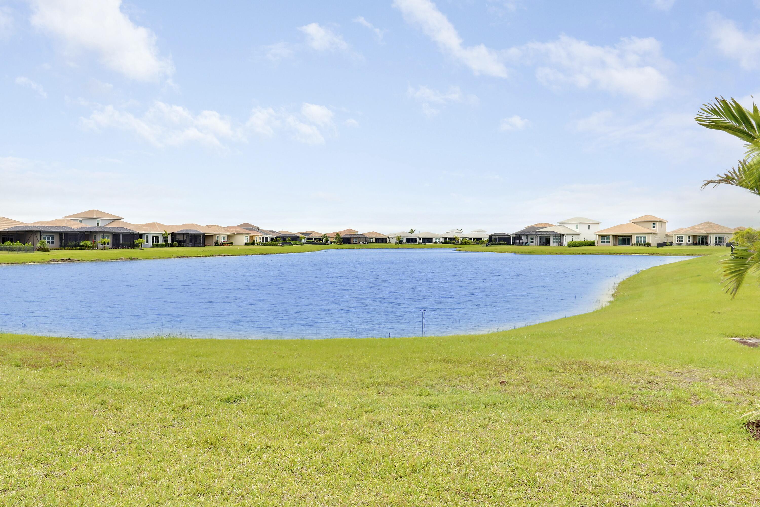 9182 Southwest Pepoli Way Port St. Lucie, FL 34987 - Photo 45 of 80 a view of a lake with houses in the back