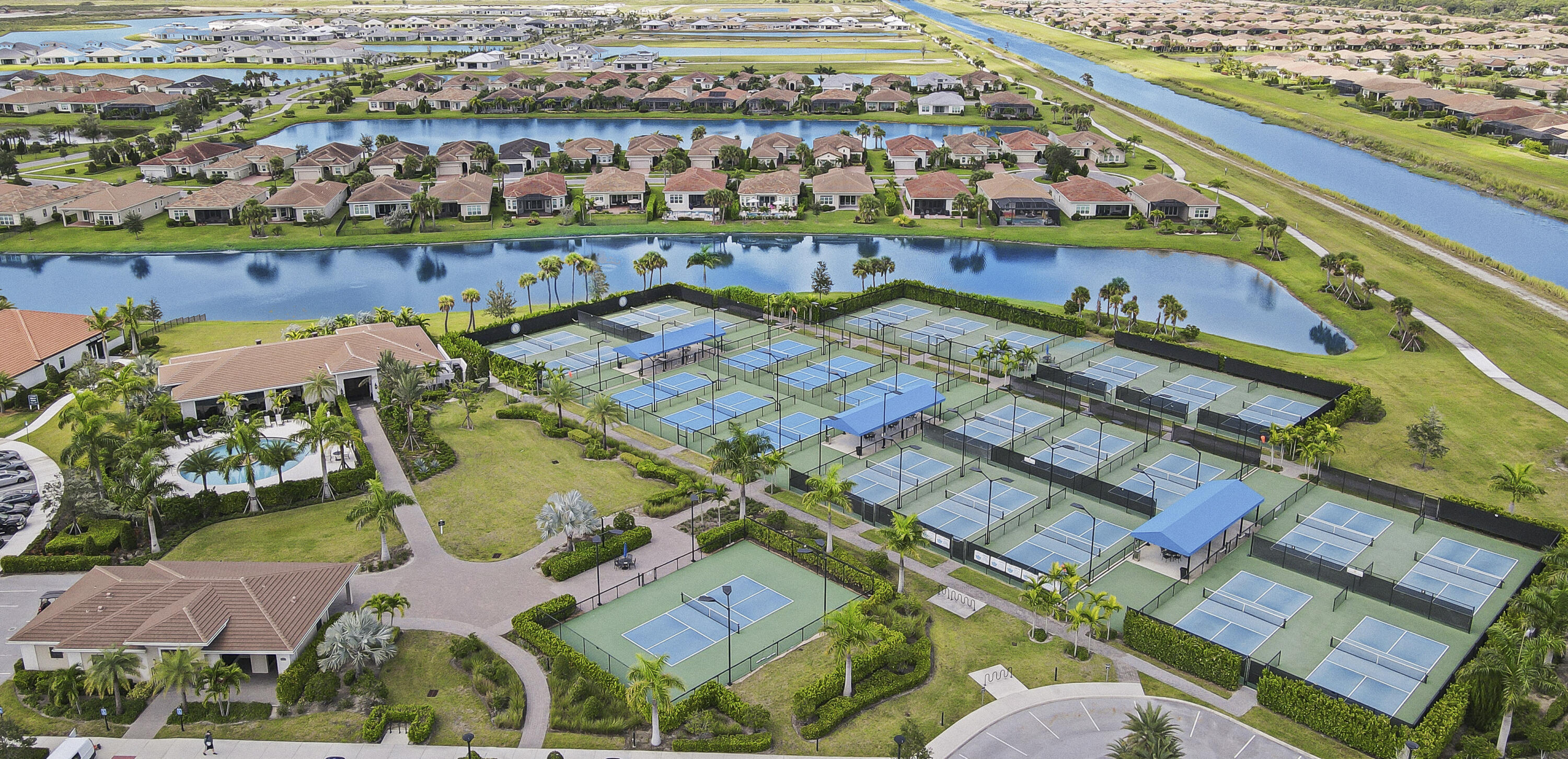 9182 Southwest Pepoli Way Port St. Lucie, FL 34987 - Photo 72 of 80 an aerial view of a city with lots of residential buildings ocean and mountain view in back