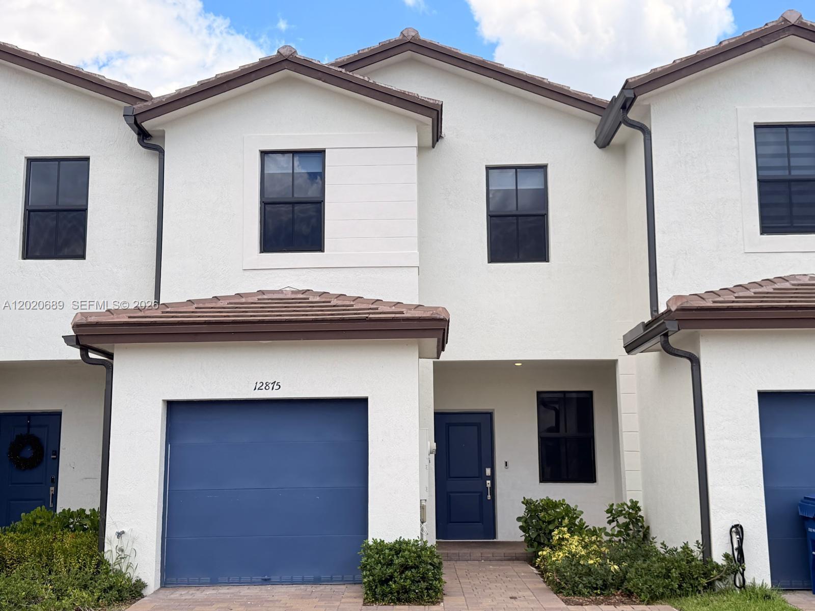 12875 Southwest 231st Terrace Miami, FL 33170 - Photo 2 of 25 a front view of a house with garden